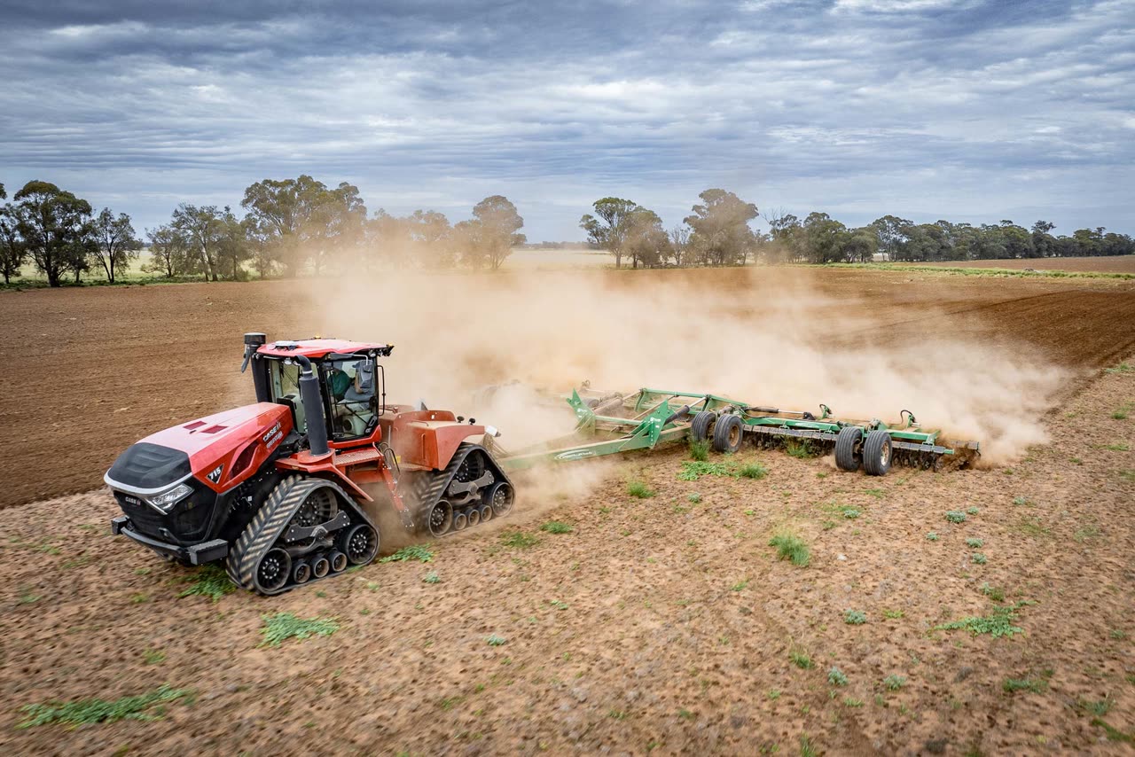 Case IH Steiger 715 Quadtrac working a paddock, dust rising behind